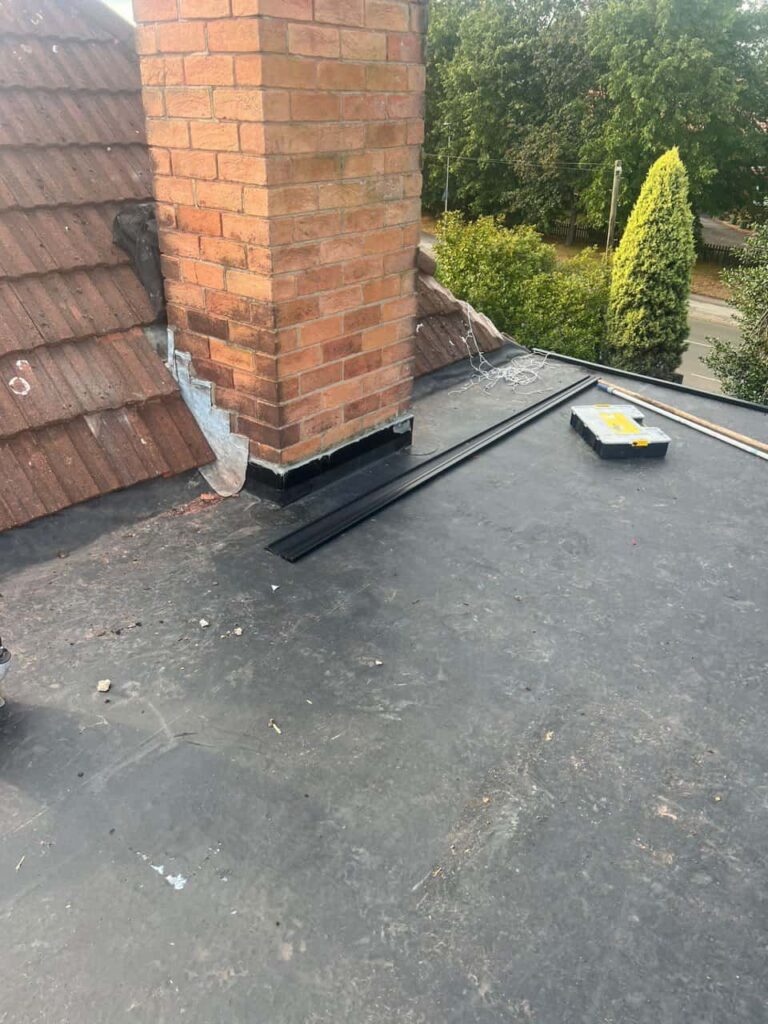 This is a photo of a flat roof which has just been repaired, there is also a chimney stack and some leadwork has also been dressed. Works carried out by Radcliffe on Trent Roofing Repairs